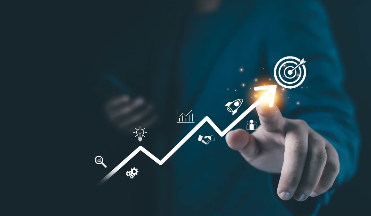Businessman touching a glowing upward arrow with strategy icons